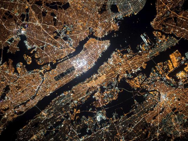 A satellite image of a glowing city at night.