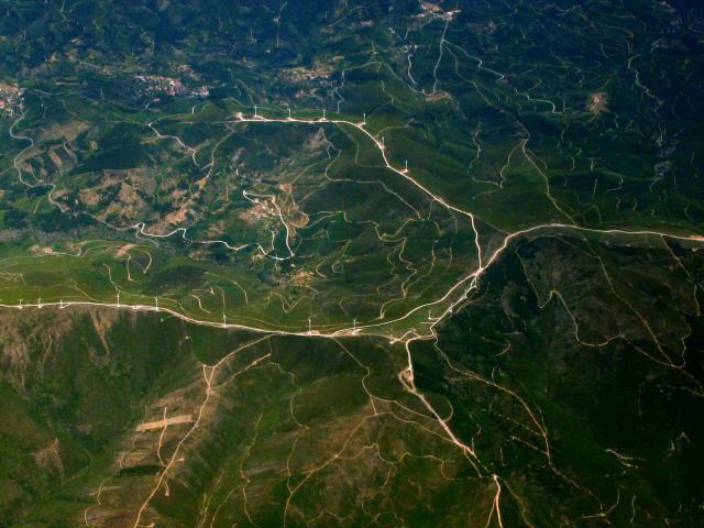 A satellite image of a series of wind turbines on a mountain.