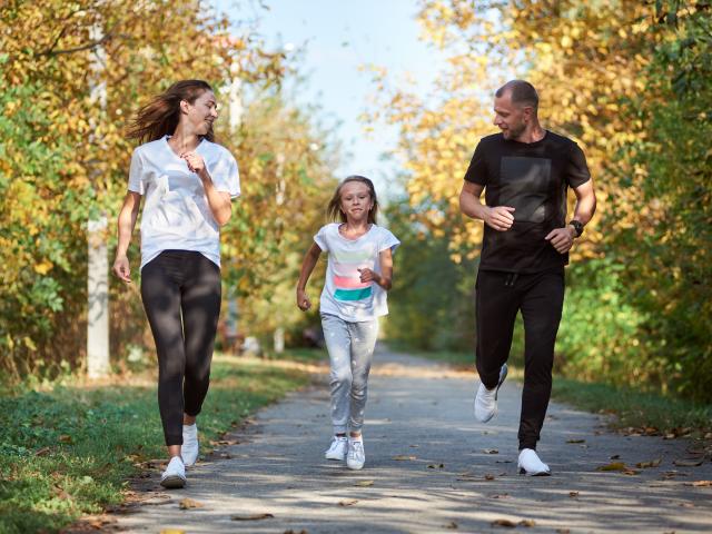 Family of three running in the park 