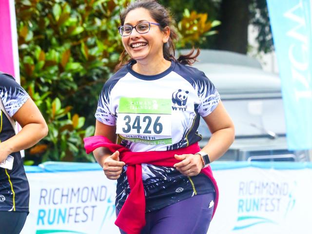WWF runner crossing the finish line at Kew Gardens 10K