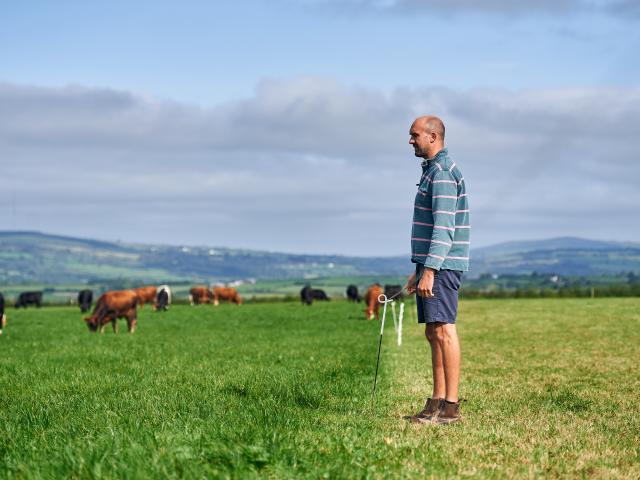 Aled, a farmer in Carmarthenshire, standing with his herd.