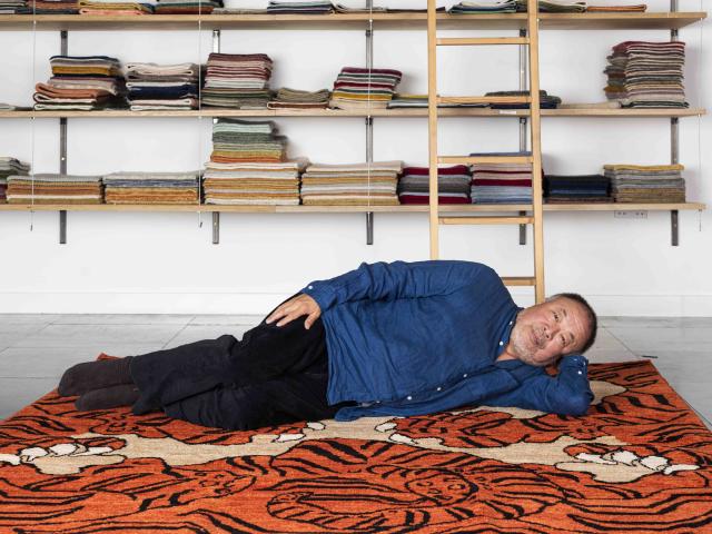 Ai Weiwei laid on his tiger rug