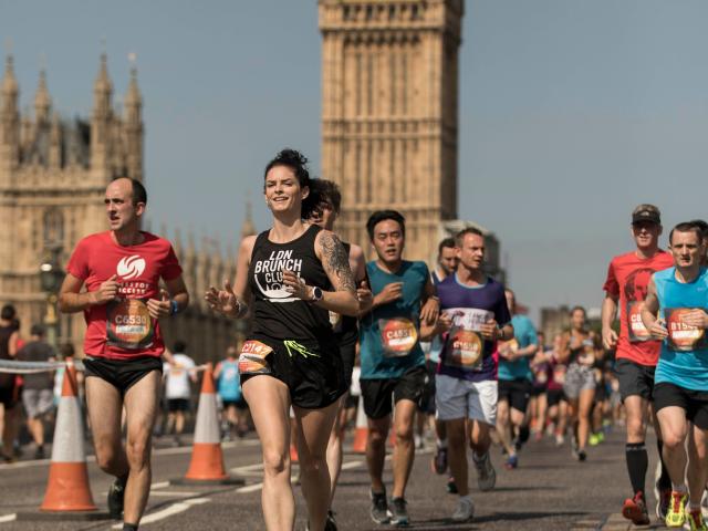 Runners passing over Westminster Bridge with Elizabeth Tower in the background