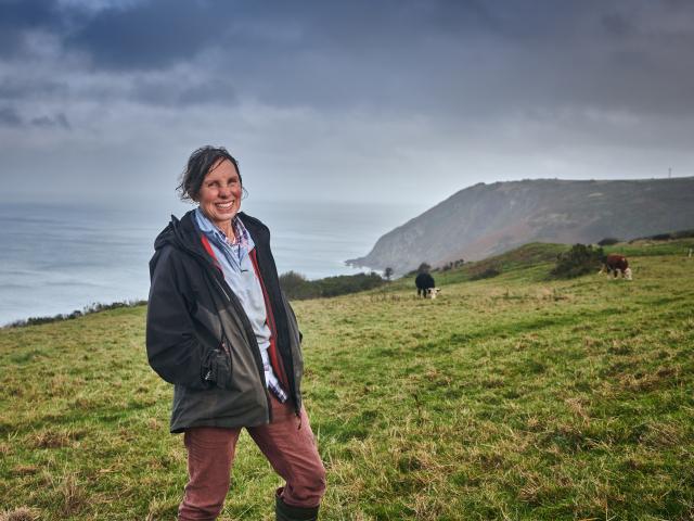 Liz on farmland close to the coast, Nantlyd farm.
