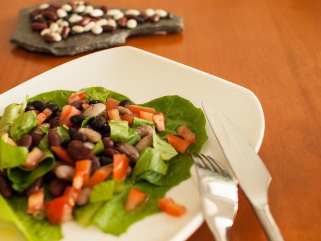Plated salad with lettuce, chopped tomatoes and beans