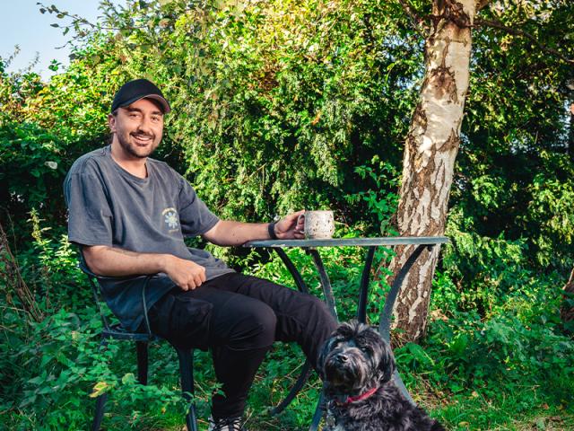 Conor McDonnell and his dog having a cup of tea in the garden
