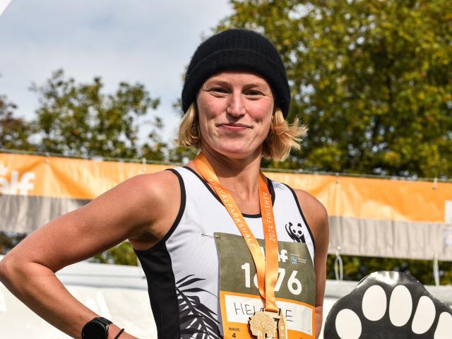 A WWF Royal Parks Half Marathon finisher with their medal.