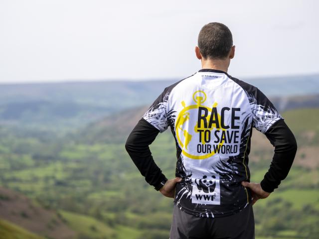 A WWF trekker looking out across a countryside view