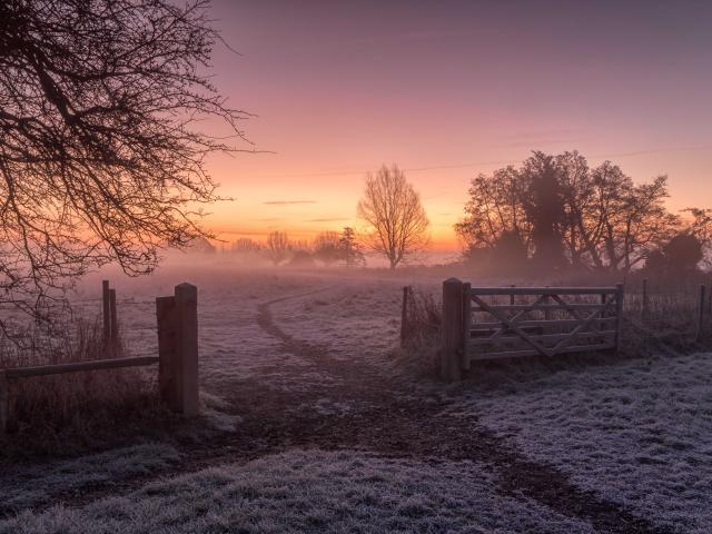 Cold, winter scene in Dedham, Colchester, UK. The frost is still covering the ground but the sun is trying hard to bring warmth to a cold, frosty morning.