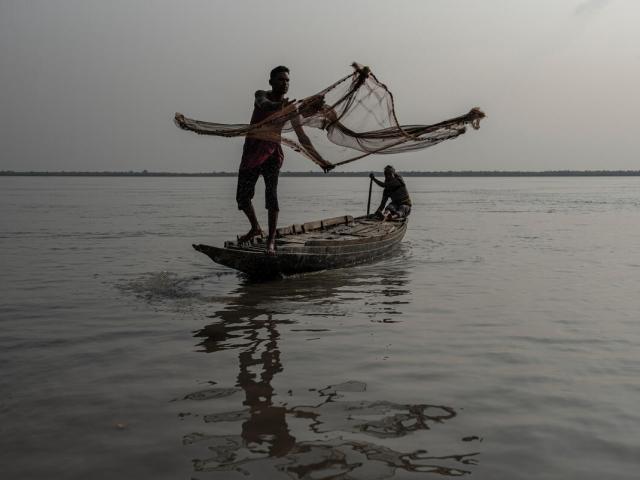 Fisherman casting a net in Bangladesh