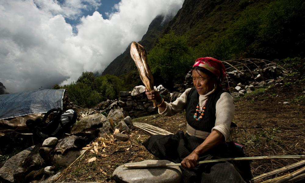 A local Tamang woman splitting bamboo in the Langtang region