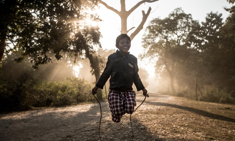 young boy skipping