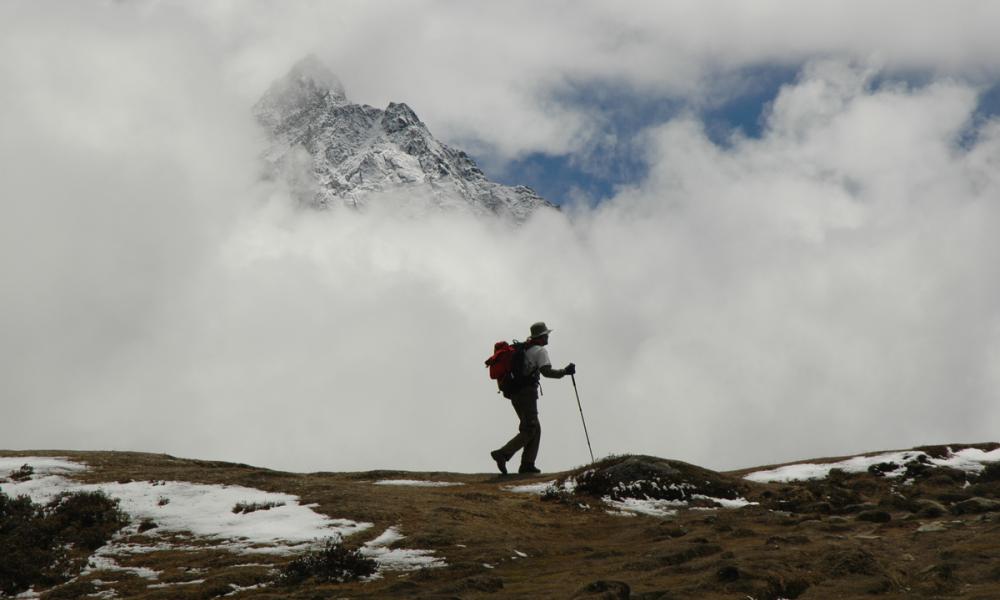 A lone trekker on a trail in the Himalayas near Mount Everest, Nepal.