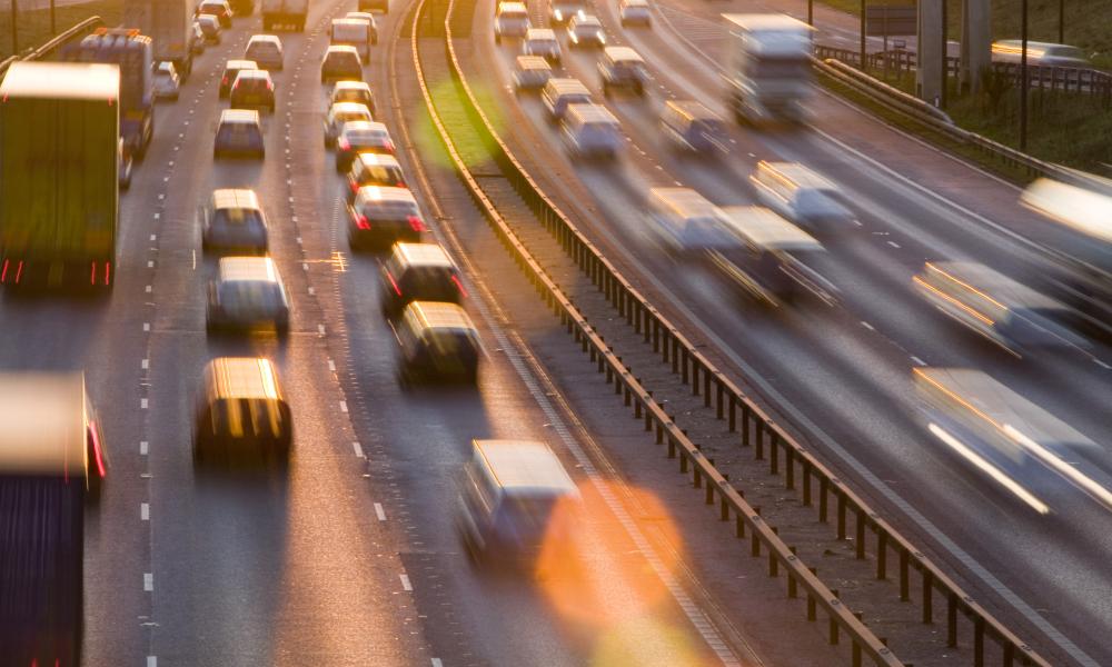 Rush hour traffic on the M60 motorway near Manchester at sunset, UK