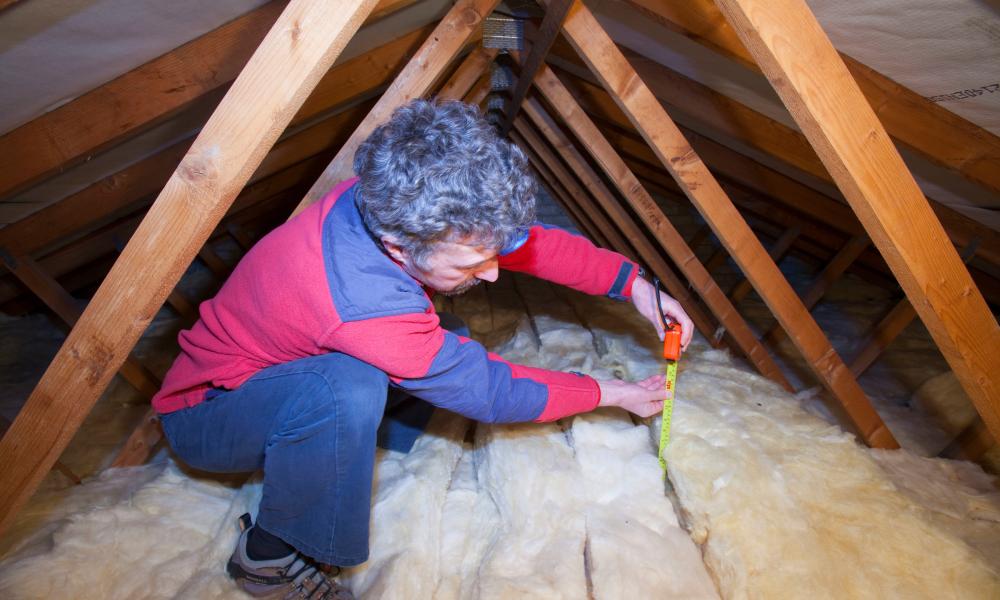Man fits insulation to a home