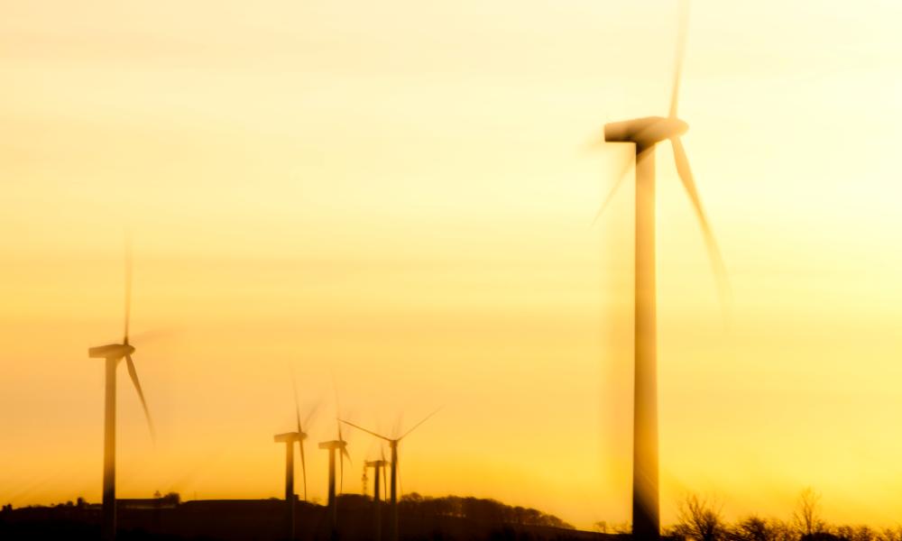 A windfarm on the west coast of Cumbria near Workington at sunset, UK.