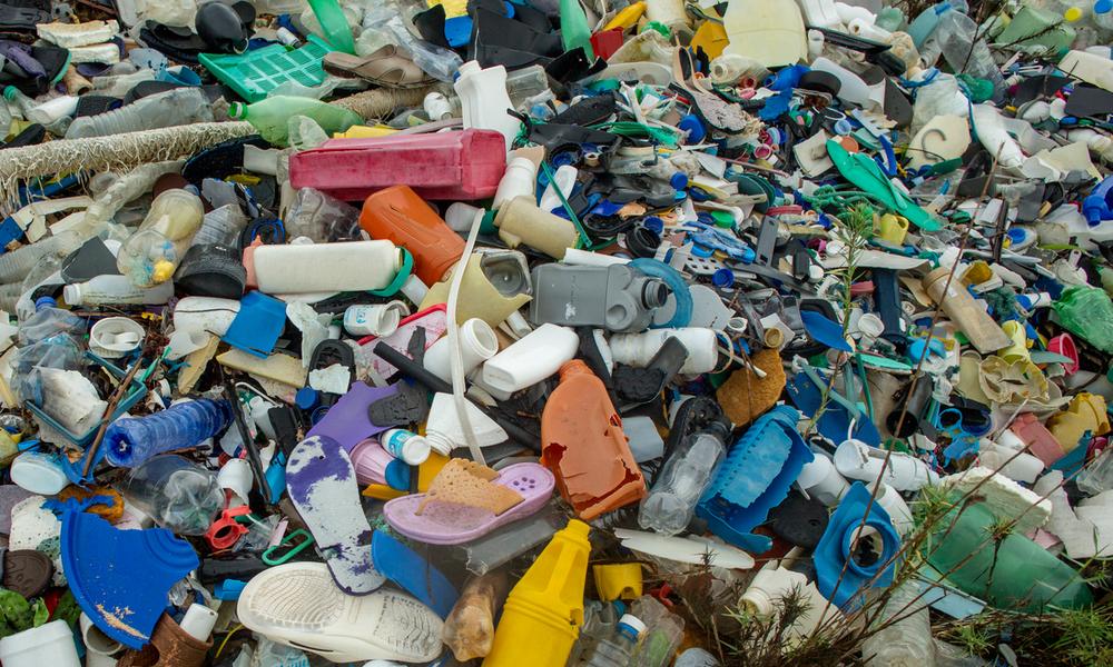 Plastic trash gathered at one end of the beach on Rubu island
