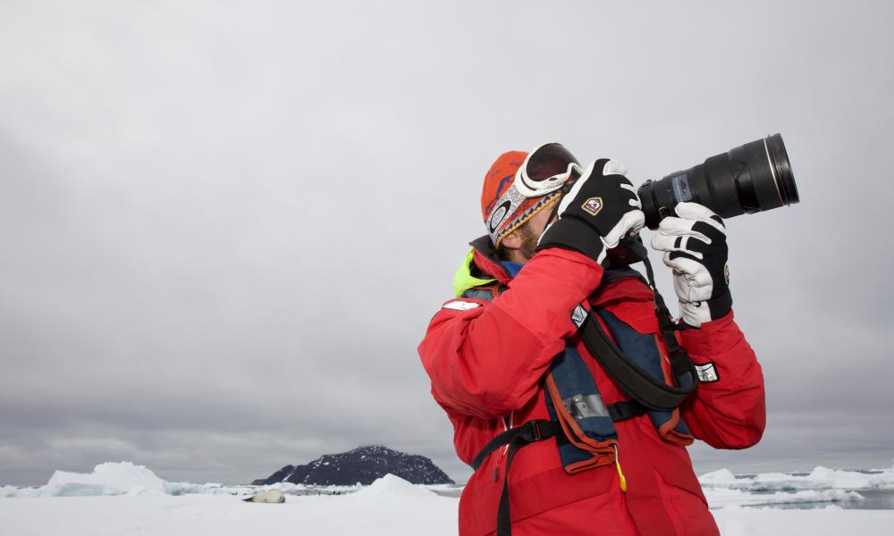 Dr Ari Friedlaender taking photos in the Antarctic Peninsula.