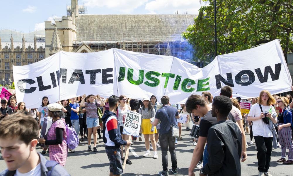 People protesting at an organised UK Student Climate Network strike at Parliament Square, May 2019, London.