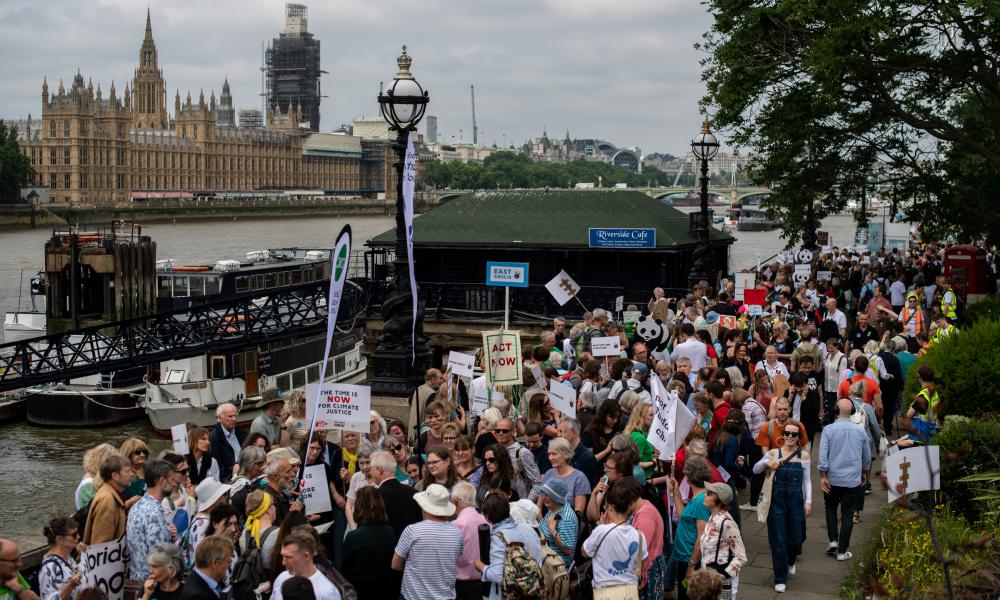 Lobbyists line the banks of the River Thames to speak with their local MP's on climate issues in Westminster, London on June 26, 2019.