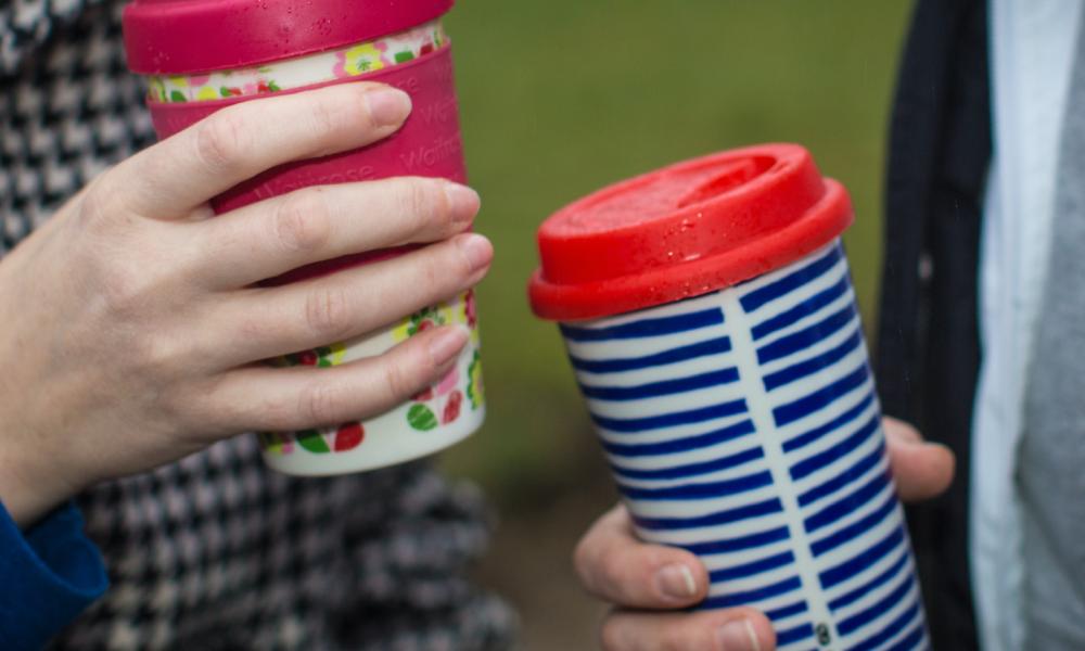 Coffee drinkers carry a reusable coffee cup in Berkhamsted, England.
