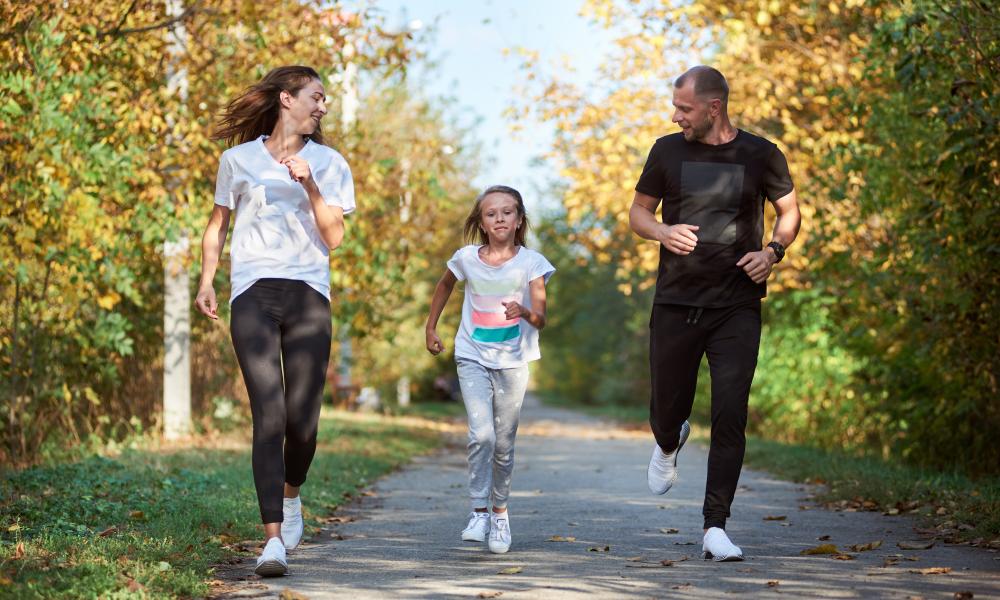 Family of three running in the park 