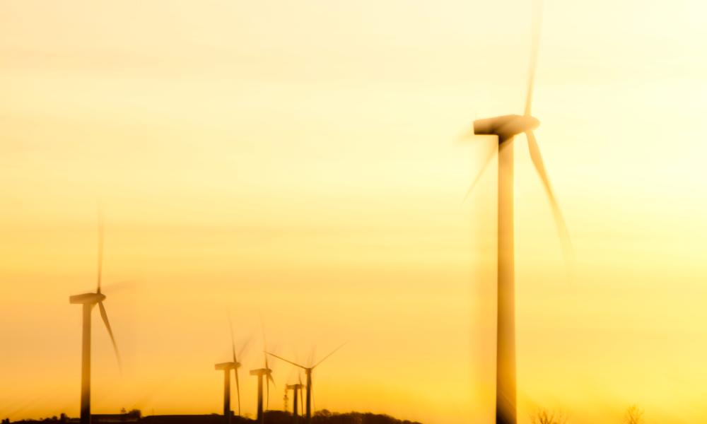 A windfarm on the west coast of Cumbria near Workington at sunset, UK.