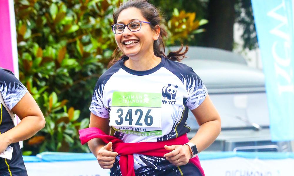 WWF runner crossing the finish line at Kew Gardens 10K