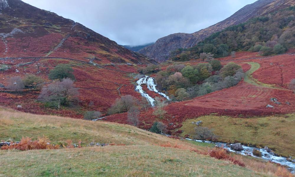 View looking up towards a stream running through a valley in Snowdonia. 