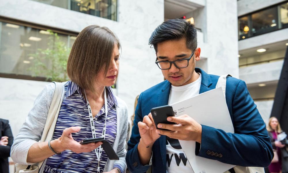 Two people on their mobile phones