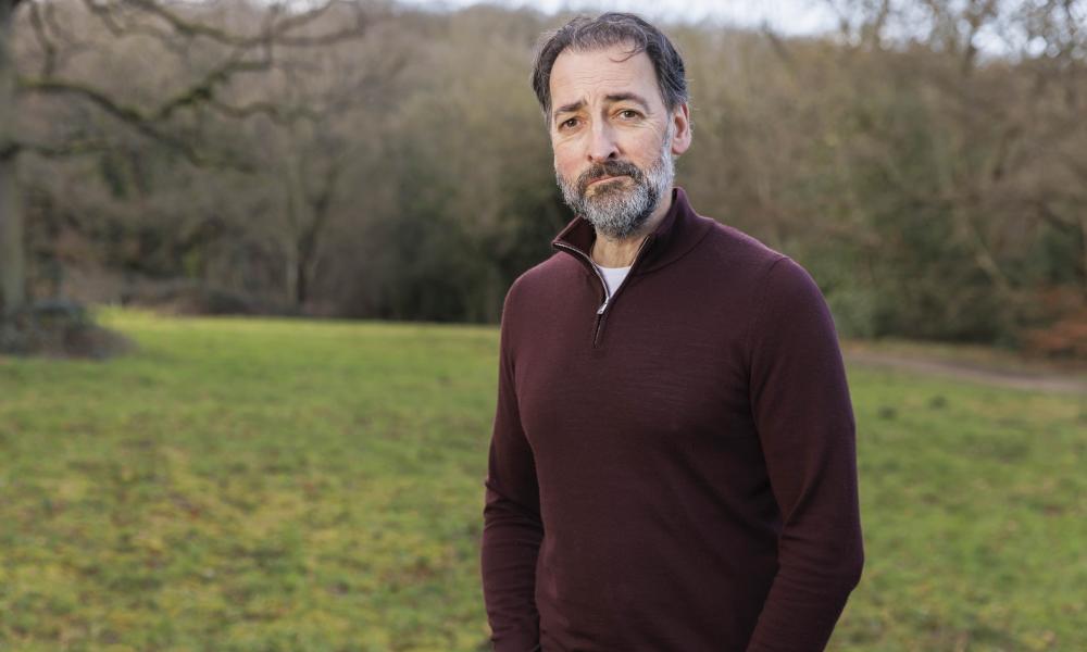 WWF Fellow and impressionist Alistair McGowan stood in a green field with trees all around