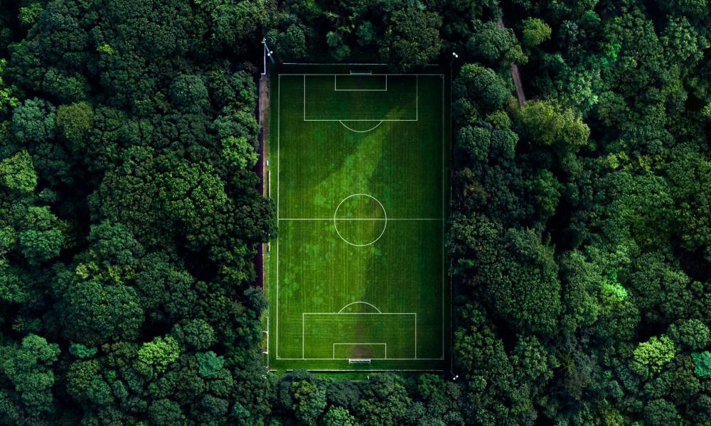 aerial shot of Football field in forest 