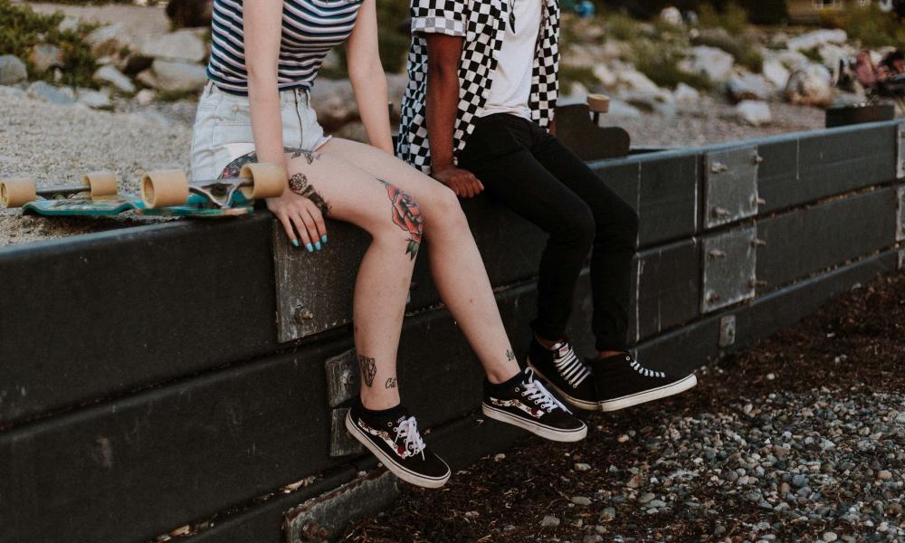 Fashionable teens hanging out on wall