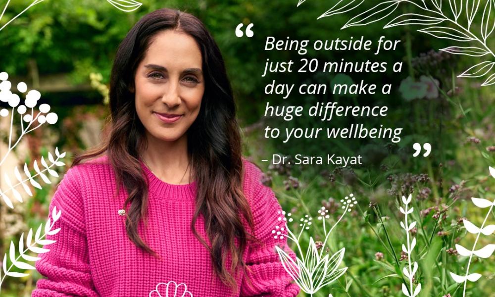 Dr Sara in pink jumper in garden with quote on nature