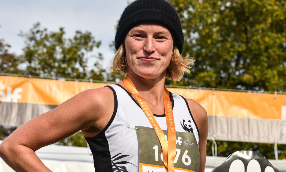 A WWF Royal Parks Half Marathon finisher with their medal.