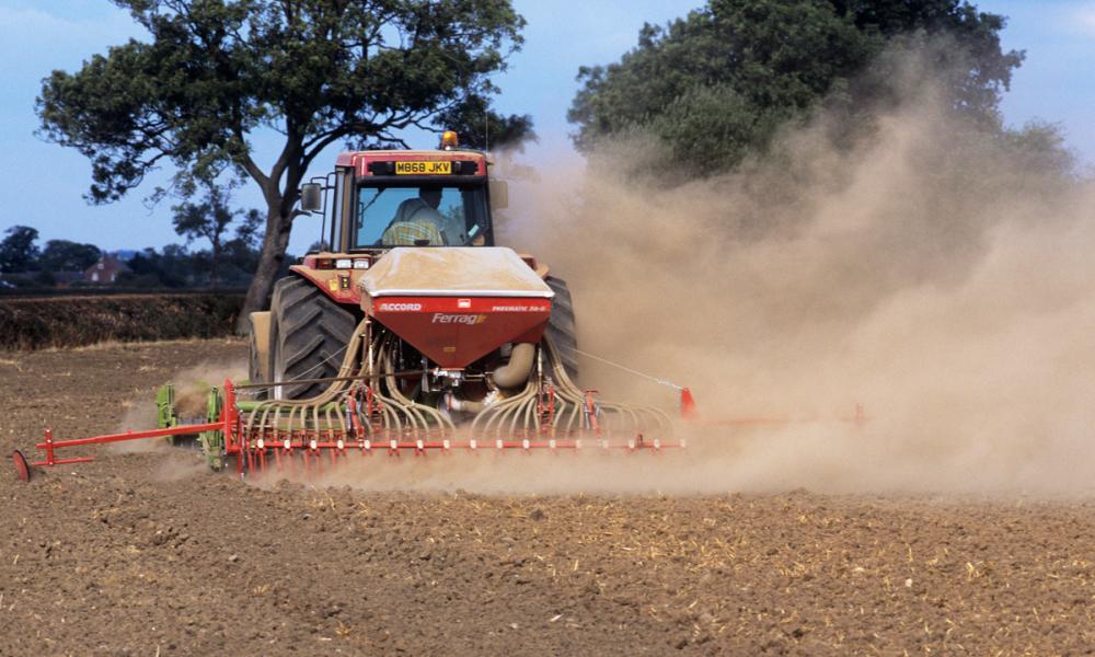 Tractor on farmland during a drought, Warwickshire, UK