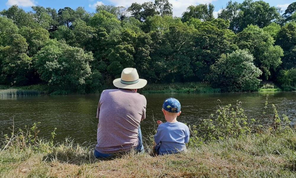 Grandpa and Grandson take a moment by a river Nottinghamshire