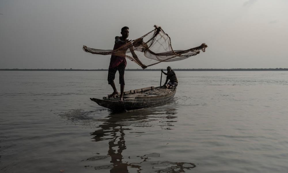 Fisherman casting a net in Bangladesh