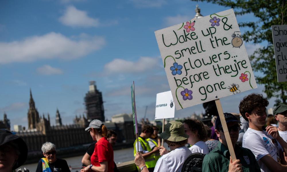 Environmental lobby of Parliament sign wake up and smell the flowers before they are gone