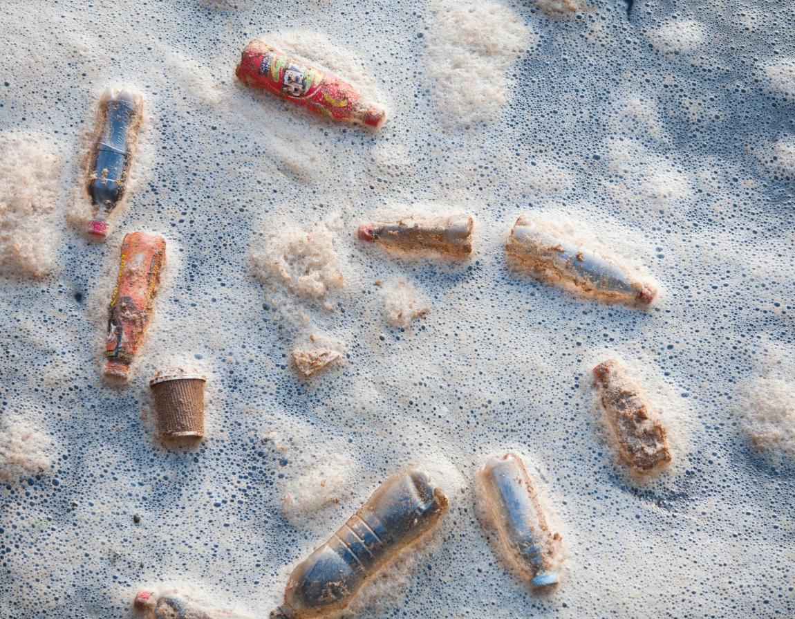 Plastic rubbish bottles floating in a dock in middlesbrough, Teeside, UK, in foam