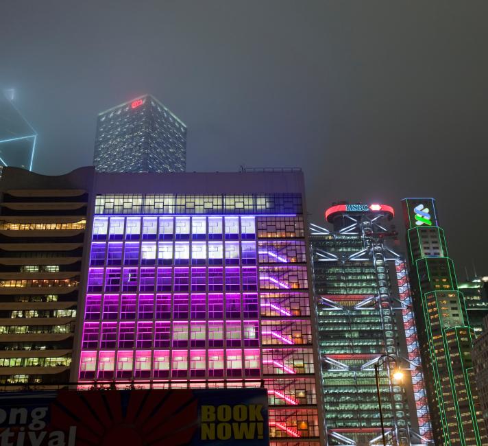 Office blocks lit up at night in Hong Kong, China.