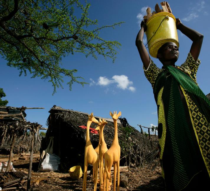 Wooden carvings from Lunga Lunga Handicraft Co-operative Society, Kenya, and woman carrying wood Lunga Lunga Handicraft Co-operative Society was set up a year ago. 