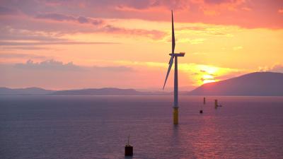 Coastal wind farm at sunset reversed