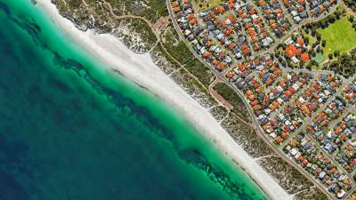 An aerial photograph of houses along the coastline.