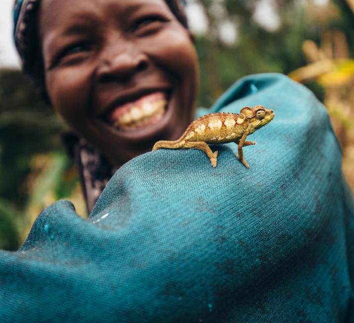 Nancy Rono, Farmer, on her farm with cameleonon on her arm. Bomet County, Mara River Upper Catchment, Kenya