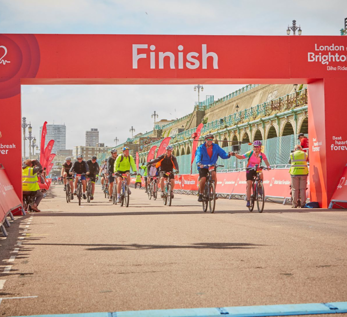 Cyclists at the London to Brighton Bike Ride Finish Line