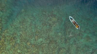 Diving skiffs just about to anchor at one of the reef north of Vanua Levu, FIji