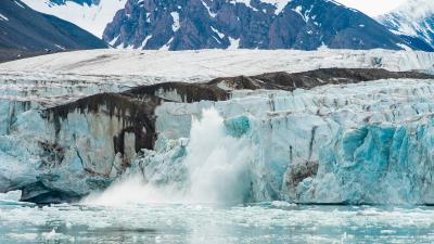 A glacier calving into the ocean