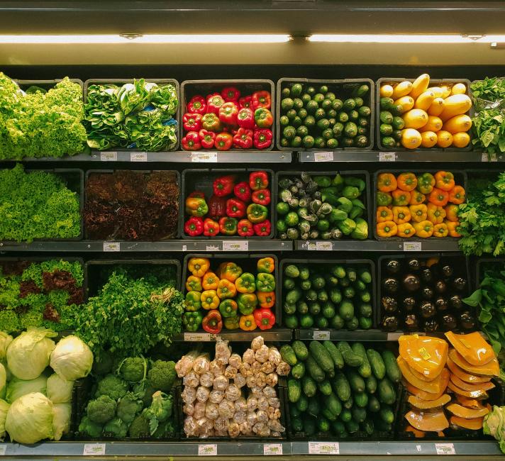 Vegetables on shelves Photo of vegetables on shelves for sale at a market or supermarket including lettuce, red, yellow and green peppers and cucumbers