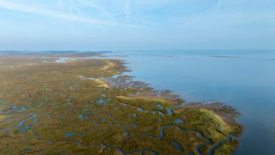 Drone shot of Stiffkey Marshes as tide comes in. Stiffkey Marshes, Stiffkey, North Norfolk, UK.